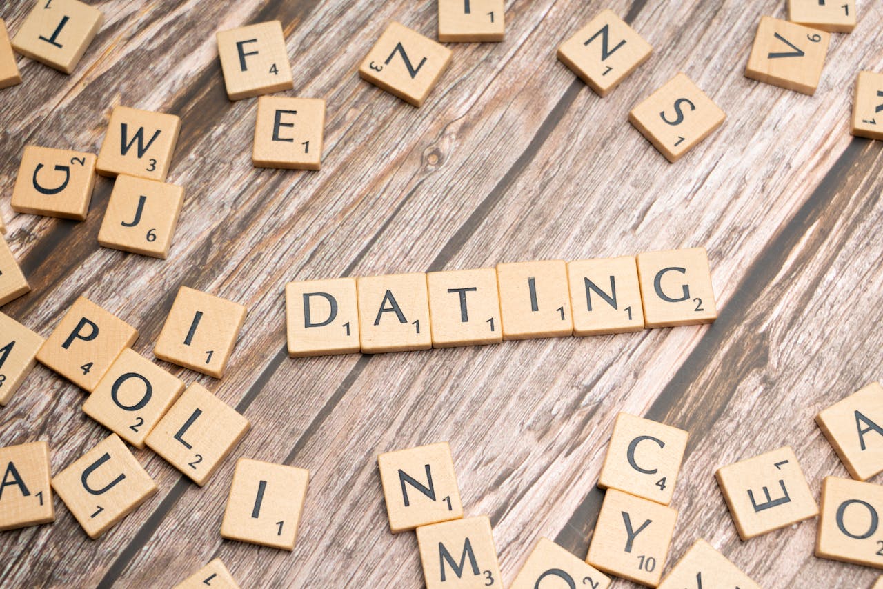 Scrabble tiles forming Dating on a wooden background, representing relationships.